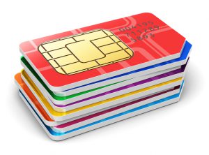 Creative abstract mobile telecommunication, wireless technology and mobility business concept: macro view of group of stacked color SIM cards for mobile phone or smartphone isolated on white background. See also: